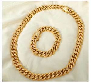 Detailed view of gold plated cuban link necklace and bracelet set with iced out zircons