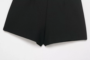 Detail shot of black suit fabric texture and clean edge stitching on the tailored skort