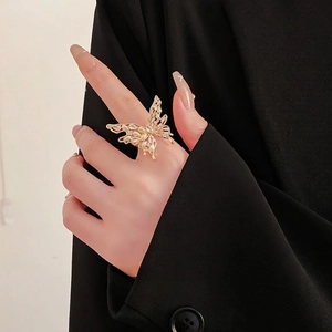 Elegant gold butterfly open ring with pearls and zircons worn on model's finger