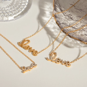 Three gold 18k stainless steel necklaces with Love pendants in crystal and plain finish