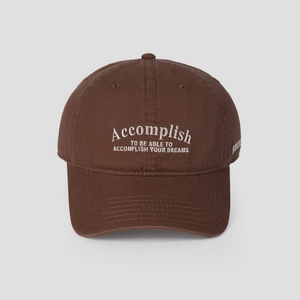 Detail of white embroidery on a vintage dark brown cotton canvas baseball cap
