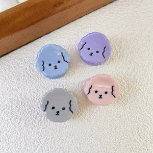 Detail of four colorful mini puppy hair claws in blue, purple, pink, and grey resin finish