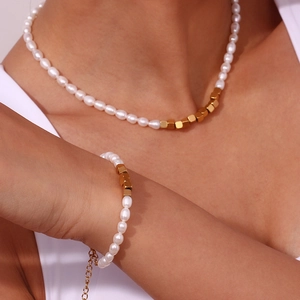 Freshwater pearl and gold square bead necklace and bracelet set worn by a model