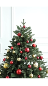 Close-up of red and gold Christmas balls with glitter and matte textures on a green tree