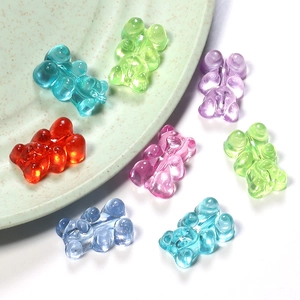 Close-up of assorted colorful transparent resin gummy bear beads with glitter for jewelry DIY