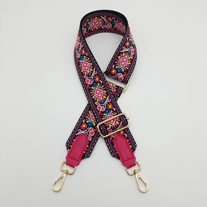 Detail of adjustable thick canvas strap with ethnic embroidery and gold metal clips
