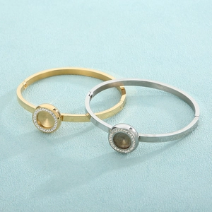 Polished gold and silver stainless steel open bracelets with rhinestone-set round bezels