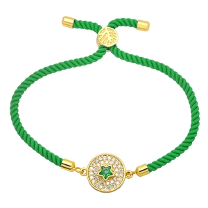 Close-up of green braided bracelet with micro-pave zircon star and golden hardware