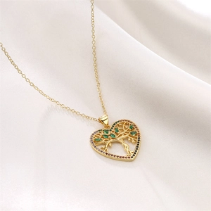 Detail of golden Tree of Life heart pendant with colorful crystals on white silk