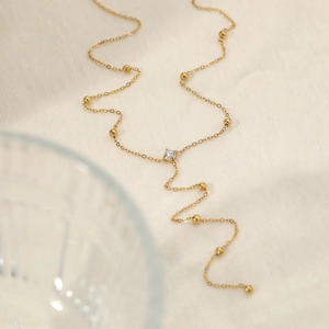 Elegant gold-plated Y-shaped necklace with tiny beads and a round cubic zirconia pendant