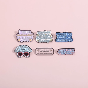 Set of six colorful enamel pins featuring poetic lyrics on a pastel pink background