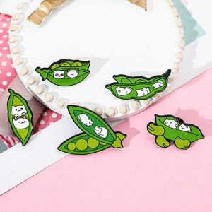Detail of five creative green pea pod cat enamel pins made of high-quality zinc alloy