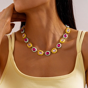 Close-up of colorful geometric enamel necklace with rhinestones on model neck