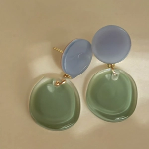 Minimalist resin drop earrings in sage green and grey blue with golden metal studs