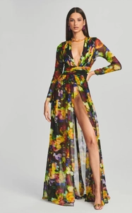 Detail of printed dress with deep V-neck, high slit, and colorful floral patterns