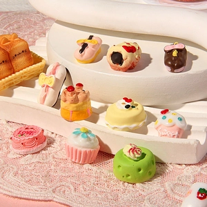 Miniature resin cake collection with sweet and love engraving on pastel dessert display