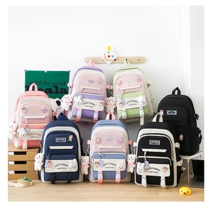 Detailed collection of colorful large school backpacks with cute plush doll keychains