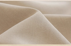 Close-up of beige linen fabric texture with soft folds for modern blackout curtains