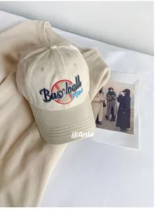 Close-up of beige cotton baseball cap featuring Baseball Mom embroidery and a red ball