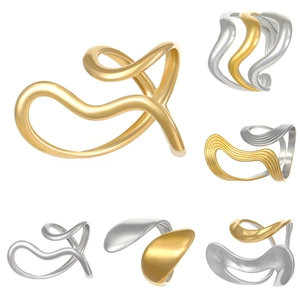 Macro view of geometric gold and silver rings with abstract wavy lava design detail