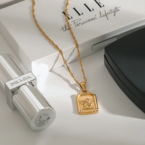 Gold angel relief pendant necklace with crystal accents and sleek rope chain
