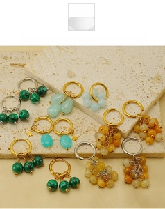 Detail of bohemian gold hoop earrings with malachite beads and golden star charms
