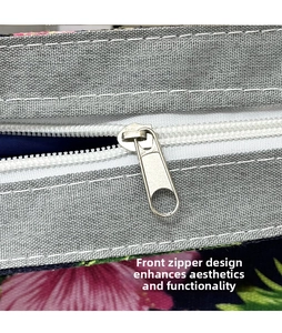Close-up of front zipper detail on gray ethnic floral canvas tote bag with smooth metal slider