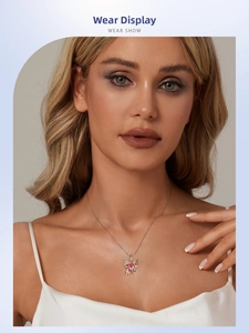 Close-up of a s925 silver butterfly necklace with a pink heart stone on a model