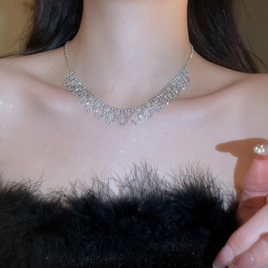 Close-up of sparkling rhinestone bow necklace on model with elegant lighting