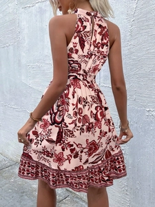 Detail of floral halter neck dress back featuring elastic waist and vibrant tropical print