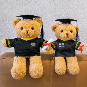 Detail view of graduation teddy bears in academic gowns with customizable logo areas