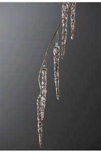 Macro detail of acrylic Christmas icicles with gold glitter hanging on golden branches