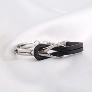 Men's titanium steel bracelet featuring black PU leather with a silver infinity knot design