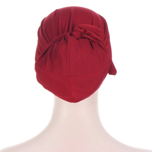 Deep red knotted chemo turban hat in soft knit fabric shown from the back view