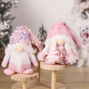 Detail of pink sequin hats and plush texture on handmade Christmas gnome couple