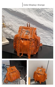 Close-up of orange backpack with punk rivet studs and metal cross detail
