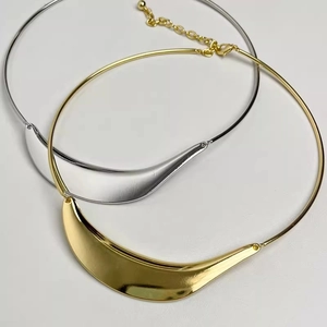 Close-up of gold and silver metallic tube necklaces with adjustable lobster clasp closures