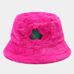 Detail shot of plush rose pink bucket hat featuring green clover embroidery texture
