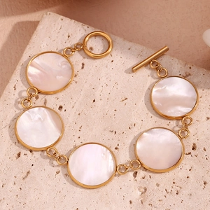 Detail of 18K gold plated stainless steel bracelet with white shell inlays and OT clasp