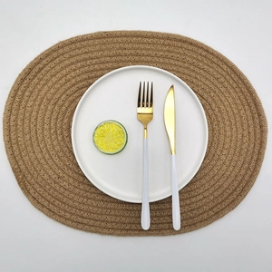 Oval braided jute placemat with heat resistance for dining table setting with tableware