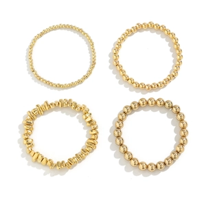 Set of four gold-toned bracelets featuring various bead styles and heart charm details
