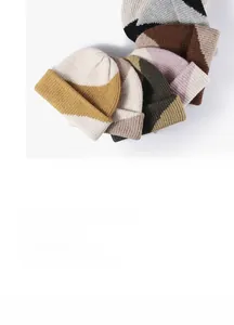 Close-up of color-block chunky knit beanie hats in various trendy autumn color schemes