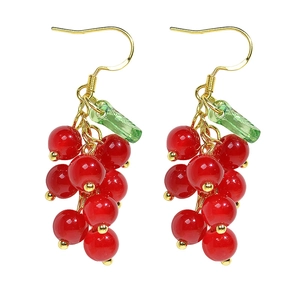 Red berry cluster long earrings with green leaves and golden hooks on white background