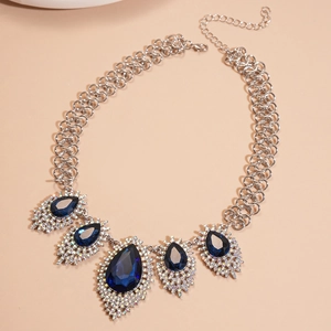 Detailed view of vintage silver chain necklace with five navy blue crystal teardrop pendants