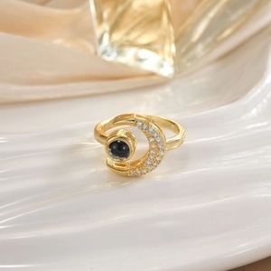 Detail of gold crescent moon ring with black onyx and micro-set cubic zirconia stones