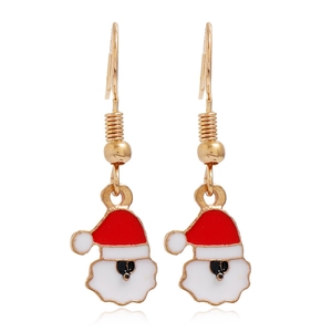 Detailed close-up of Santa Claus hook earrings with red and white enamel on golden metal