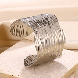 Detail view of hammered texture on wide open cuff bracelet made of silver stainless steel