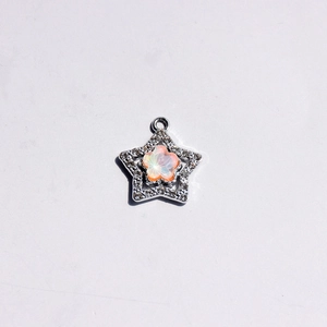 Macro view of alloy star pendant with macaron flower opal and sparkling zircon inlay