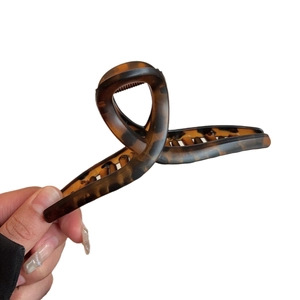 Large tortoiseshell acetate hair claw clip with elegant twist design for women