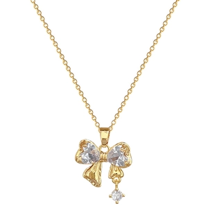 Elegant gold titanium steel necklace featuring a bow pendant with heart-shaped zircon stones